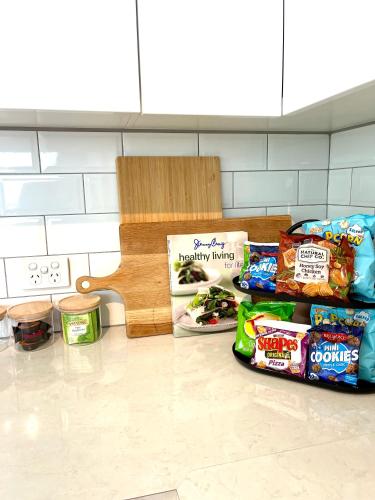 a counter with some food on the floor and a bench at Sunshine Retreat Modern 3BR Haven in St Marys