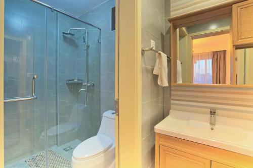 a bathroom with a toilet and a glass shower at Spacious, beautiful, elegant, with natural light 1 bedroom Apartment in Nairobi