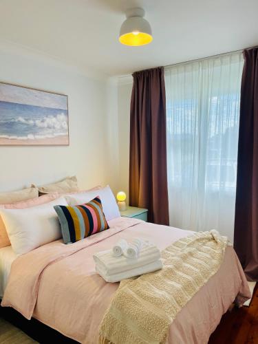 a bedroom with a bed with two towels on it at Sunshine Retreat Modern 3BR Haven in St Marys