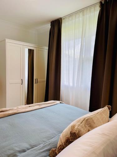 a bedroom with a bed and a window at Sunshine Retreat Modern 3BR Haven in St Marys