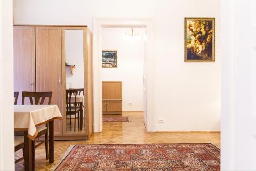 a living room with a table and a dining room at Authentic Budapest Apartment in Budapest