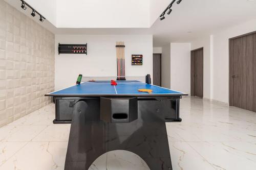 a ping pong table in the middle of a room at Chalét de Lujo en Rozo! in Rozo