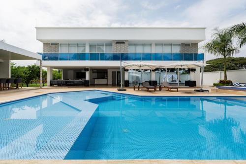 a large swimming pool in front of a house at Chalét de Lujo en Rozo! in Rozo