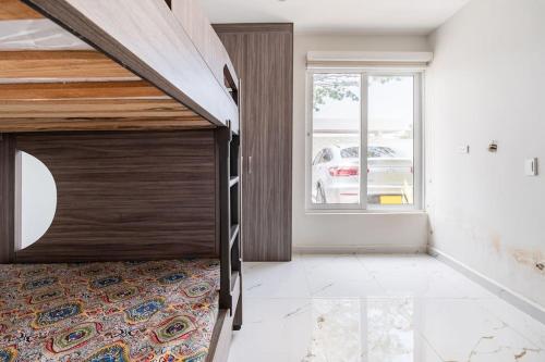 a bedroom with a large bed with a wooden door at Chalét de Lujo en Rozo! in Rozo