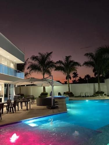 a swimming pool in a house at night at Chalét de Lujo en Rozo! in Rozo