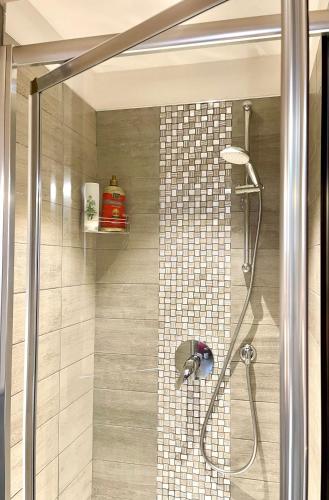 a bathroom with a shower with a glass door at Dimora di Charme Rooms & Apartments in Peschiera del Garda