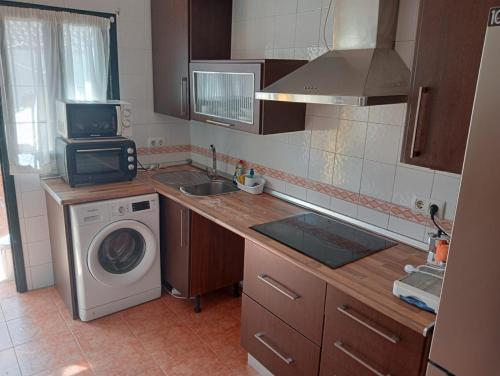 uma cozinha com uma máquina de lavar roupa e uma máquina de lavar roupa em ALBORADA TRES em Burguillos
