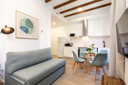 a living room with a couch and a table at Moontels Plaza de Vannes in Valencia