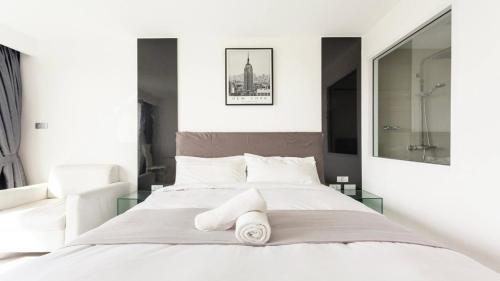 Un dormitorio con una cama con toallas. en Pattaya City Center Residence by K2, en Pattaya central