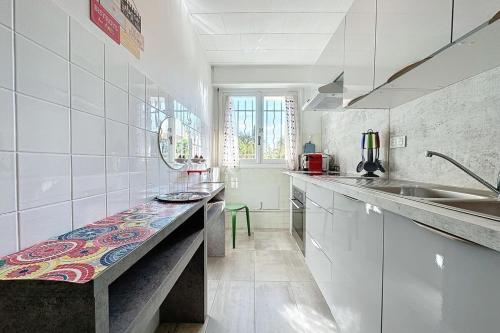a kitchen with a counter with a bench in it at Apartment 2 room in the City Center in Le Cannet