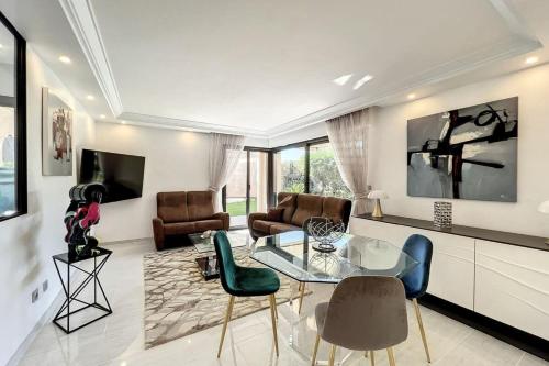a living room with a glass table and chairs at 3-room apartment in a high-end residence with swimming pool in Cannes