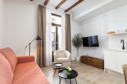 a living room with a couch and a table at Moontels Plaza de Vannes in Valencia