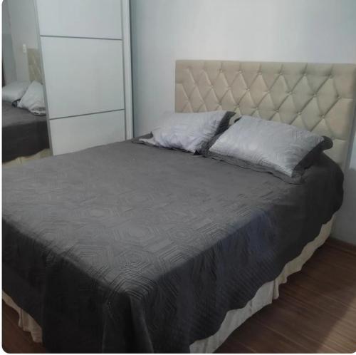 a bedroom with a large bed with a large headboard at Casa da cylla in Alto Caparao