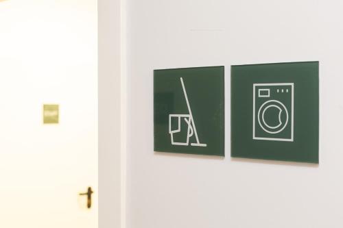 a door with three pictures of a washing machine at Moontels Plaza de Vannes in Valencia