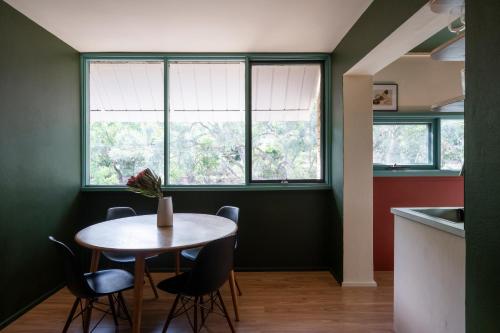 a dining room with a table and chairs and a window at Sun filled 1BR APT 2 mins to Legacy Park in Campbell