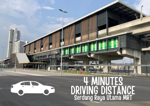 a white car parked in front of a building at Smile Hotel Serdang South City in Serdang