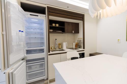an empty refrigerator in a kitchen with a counter at Wecostay Gangnam in Seoul