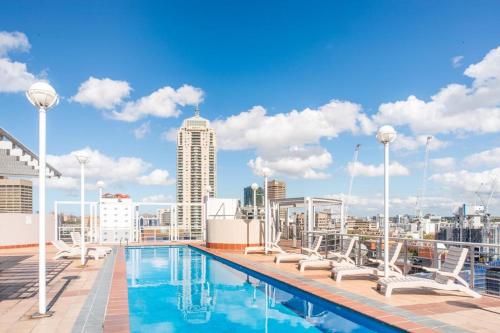 a swimming pool on the roof of a building at Darling Harbour Apartments in Sydney