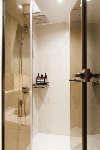 a shower with a glass door in a bathroom at Wecostay Gangnam in Seoul
