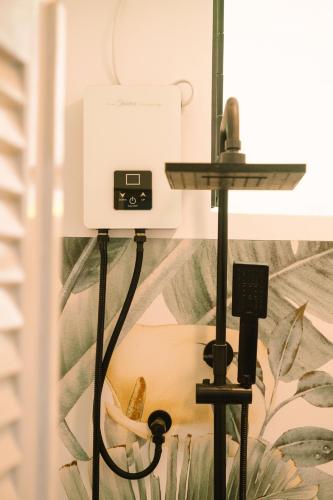 a camera on a tripod next to a wall at BIG WAVES BOUTIQUE HOTEL SIARGAO in General Luna