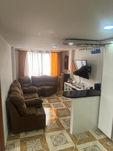 a living room with a couch and a flat screen tv at Apartamento La Hermosa in Santa Rosa de Cabal