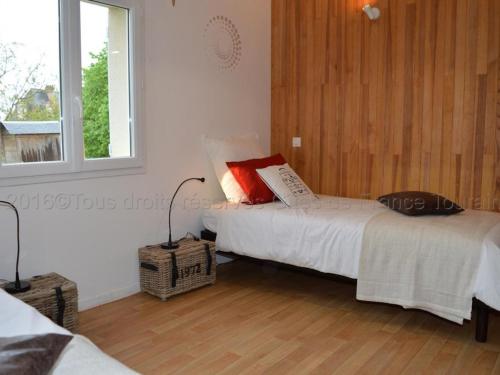 a bedroom with two beds and a window at Gîte Montlouis-sur-Loire, 4 pièces, 5 personnes - FR-1-381-95 in Montlouis-sur-Loire