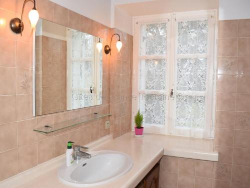 a bathroom with a sink and a mirror and a window at Maison de caractère avec jardin, climatisation et vélos près d'Amboise - FR-1-381-357 in Cangey