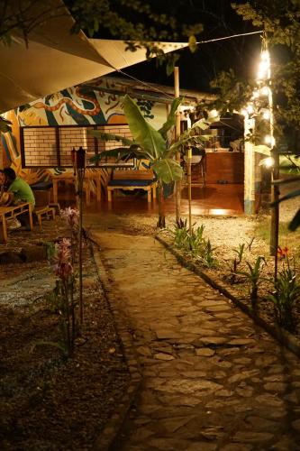 a stone path in front of a restaurant at night at Central Minca in Minca