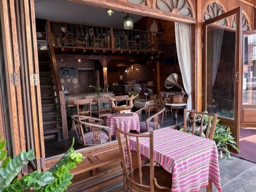 a restaurant with tables and chairs and a balcony at Rustic River Boutique in Chiang Mai