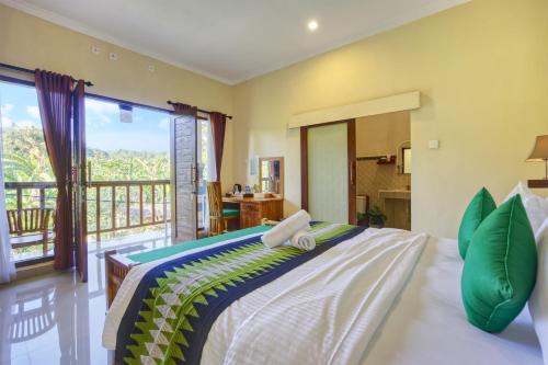 a bedroom with a large bed and a balcony at Ped Cottage in Nusa Penida