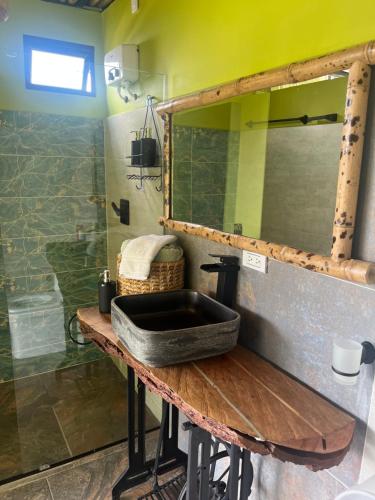 a bathroom with a sink and a mirror at Glamping ríos voladores pereira in Pereira