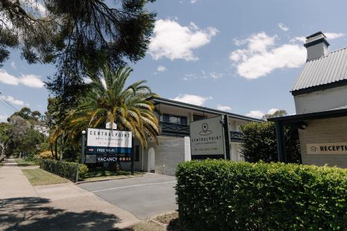 a building with a sign in front of a street at Centralpoint Motel in Wagga Wagga