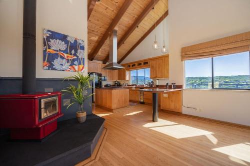 a large kitchen with a red stove in a room at Unmatched Ocean Beach and Mountain Views Family-Friendly Retreat in Moss Beach