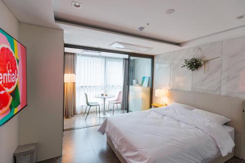 a bedroom with a bed and a table with chairs at Wecostay Gangnam in Seoul