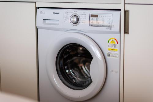 a white washing machine in a room at Wecostay Gangnam in Seoul