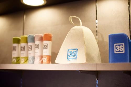 a shelf with a roll of toilet paper and books at 3s HOTEL ATSUGI in Atsugi