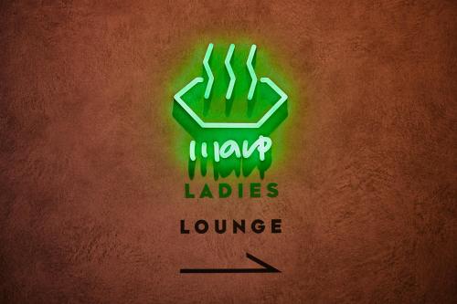 a green neon sign with the words la yard ladders lounge at 3s HOTEL ATSUGI in Atsugi