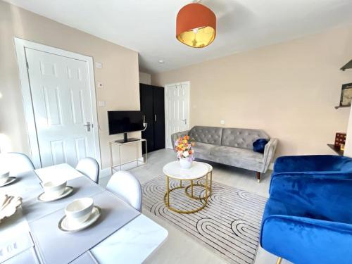 a living room with a couch and a table at Central Winchester Serviced Apartments in Winchester
