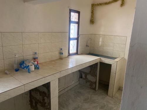 a kitchen with a counter with a window in it at CREPE GAME in Nouakchott