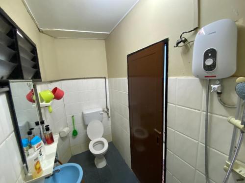 a small bathroom with a toilet in a room at JAST 9 HOMESTAY in Port Dickson