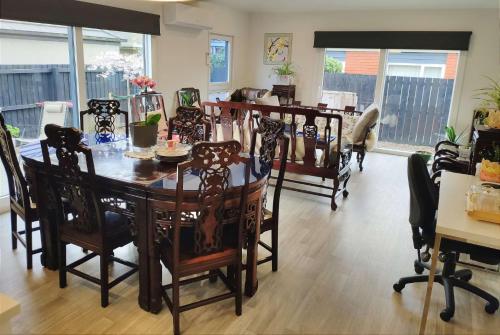 a dining room with a table and chairs at LilyのHome Elegant Retreat near Riccarton Mall in Christchurch