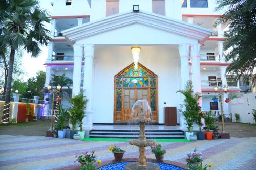a building with a fountain in front of a building at Hotel Harsh Garden in Begusarai