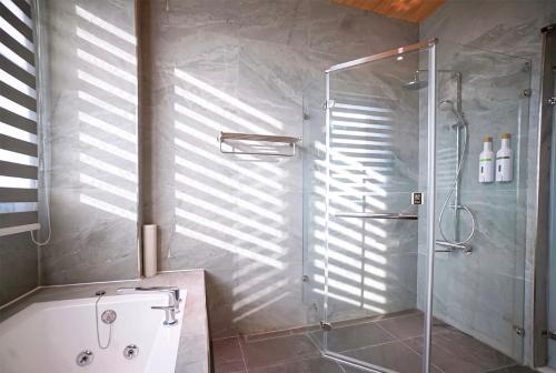 a bathroom with a shower with a glass door at Chun Yuan Zi in Hu-an-liao