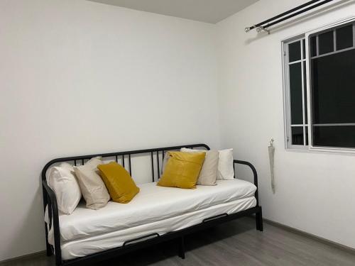 a black and white couch with yellow pillows on it at Indy 2 Bangna KM 7 Cozy Townhome near Ikea Mega Bangna 15m to Airport in Bang Kew Yai