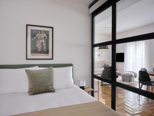 a bedroom with a bed and a living room at Sunny and Comfy 2bd Apt in Kolonaki in Athens