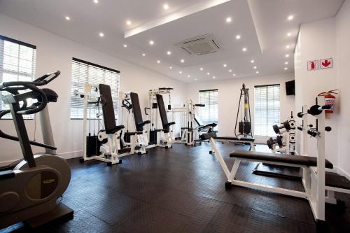 a gym with treadmills and machines in a room at 10 2nd Avenue Houghton Estate by Dream Resorts in Johannesburg
