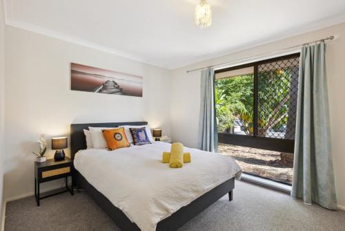 a bedroom with a bed and a large window at The Entertainer #2 in Perth