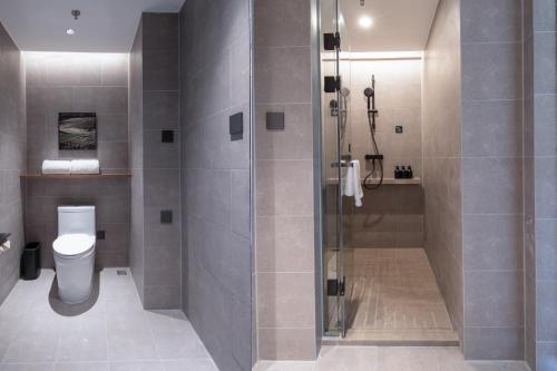 a bathroom with a shower and a toilet at Atour Hotel Zhaoqing Qixingyan in Zhaoqing
