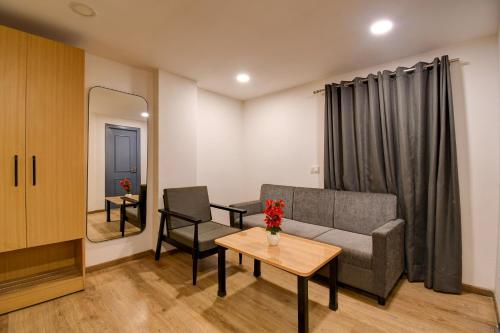 a living room with a couch and a table at Super Townhouse City Centre 2 Downtown - Managed by Company in Kolkata