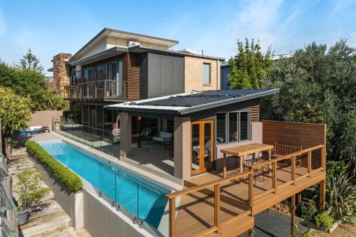 a house with a swimming pool next to a house at Jane's at Werri, Gerringong in Gerringong